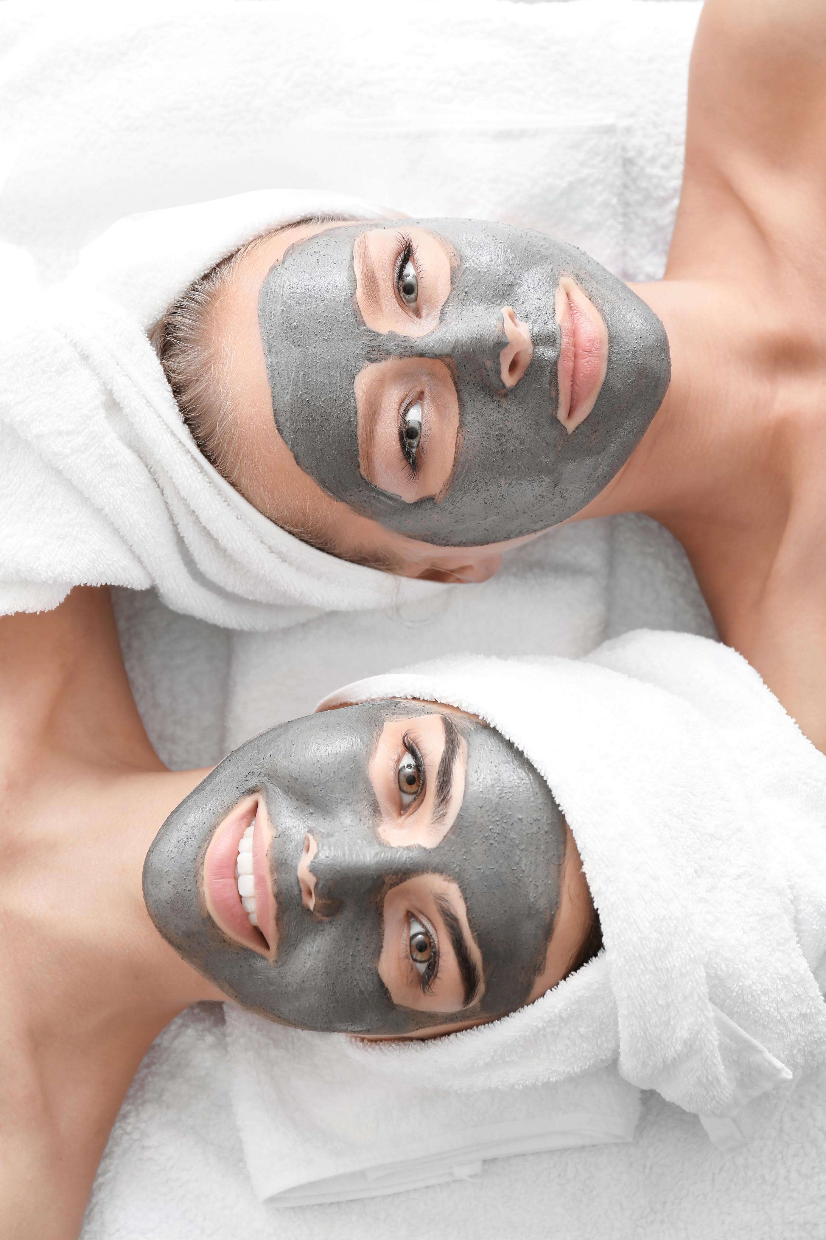 Two clients in a relaxing facial mask treatment